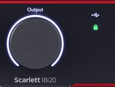 An image of the front of an 18i20 showing the output dial with the USB and lock lights to its right. The USB light above the locked light is white, and the lock light beneath is green.